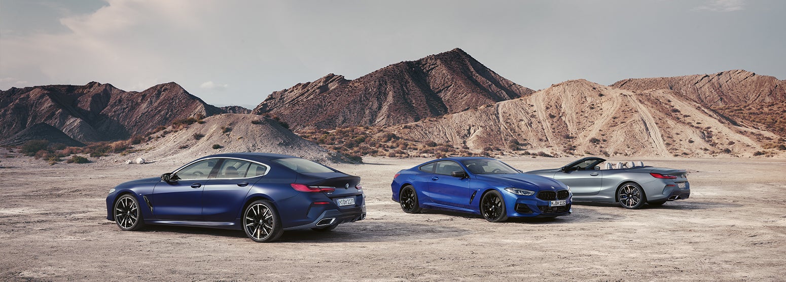 Three BMW 8 series parked in desert landscape | BMW of Sterling in Sterling VA