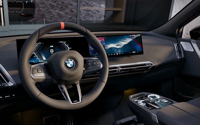 Interior steering wheel and dashboard of the BMW iX M70. | BMW of Sterling in Sterling VA