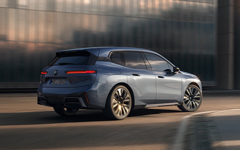 The BMW iX driving with the front wheel turned. | BMW of Sterling in Sterling VA